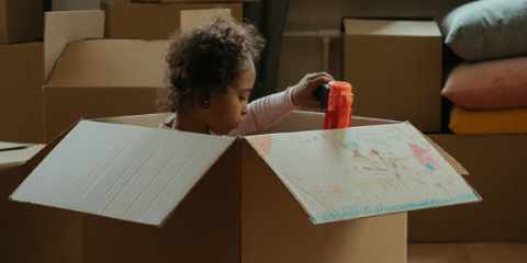 toddler playing in cardbox